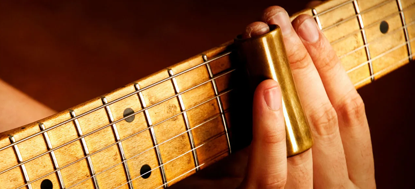 Cómo tocar una cigar box guitar con slide: técnicas y consejos